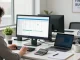 Accountant engaged in small business accounting with financial documents and software